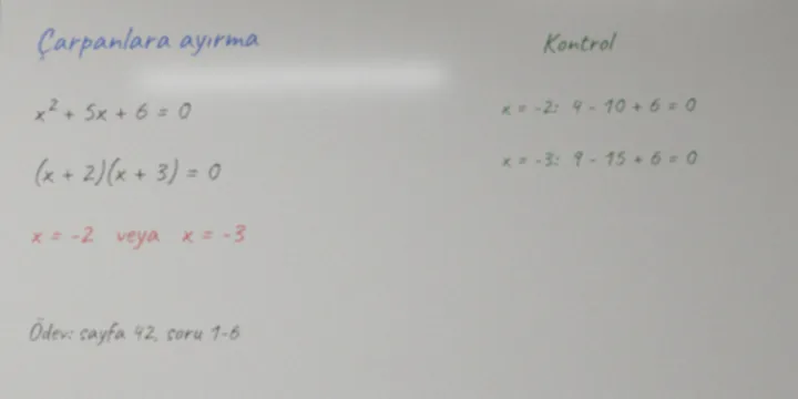 Raw camera image: glare on the board, grey and faint writing.